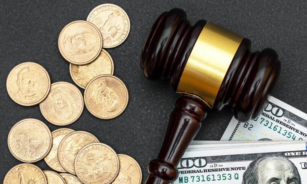 Forensic Accounting A gavel signifying criminal confiscation rests atop a stack of money.